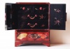 264.   Vintage japanese lacquer jewelry box with characteristic motifs on the top and round sideways. : 